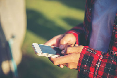 Midsection of woman using phone 