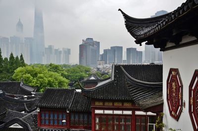 Modern buildings against cloudy sky