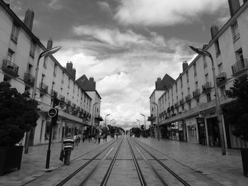 Street amidst buildings in city against sky