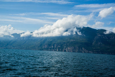 Scenic view of sea and mountain against sky