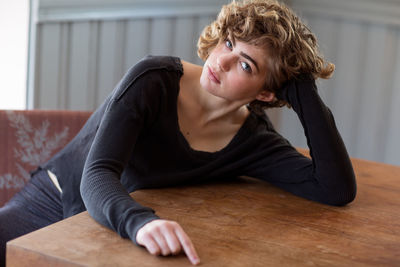 Portrait of young woman sitting on sofa