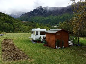 Scenic view of house on grassy field