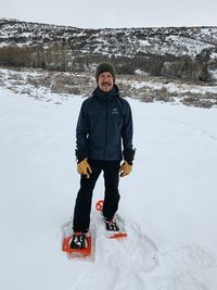 Full length of man standing on snowy field