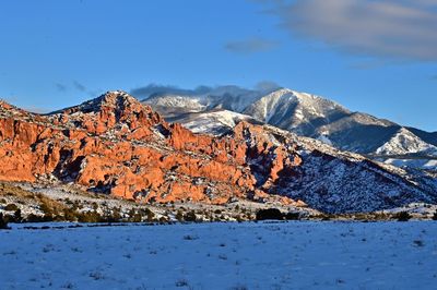 Scenic view of snowcapped mountains against clear blue sky