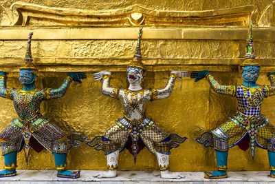 Giant statue with pagoda in wat phra kaew or wat phra si rattana satsadaram in bangkok, thailand