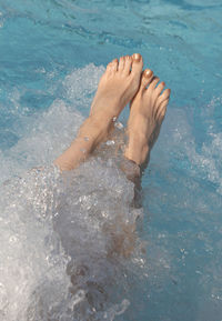 Low section of person in swimming pool
