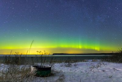 Scenic view of frozen lake against sky at night