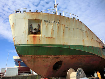 Low angle view of boat moored against sky