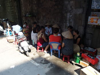 People playing cards against wall