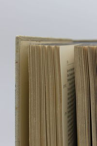 Close-up of book on table against white background