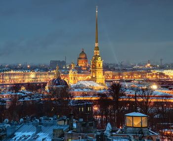 Illuminated buildings in city at dusk