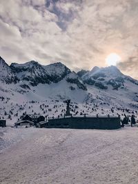 Scenic view of snow covered mountains against sky