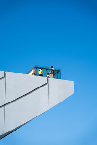 Low angle view of building against clear blue sky