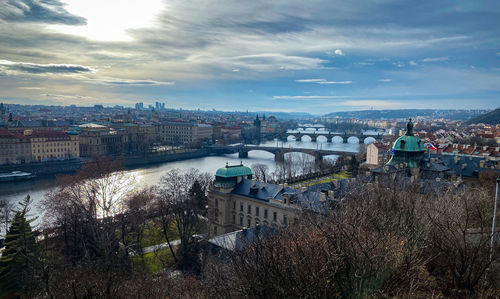 High angle view of river amidst buildings in city against sky