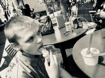 Portrait of boy with drink on table at restaurant