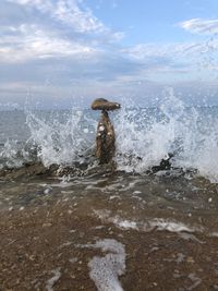 Scenic view of sea waves splashing on shore