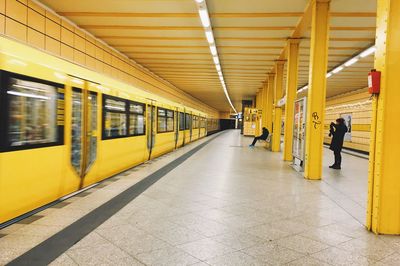 View of yellow train on railroad station platform