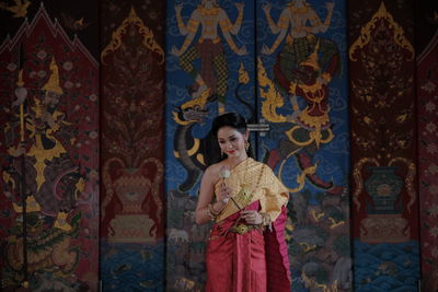 Woman standing against wall