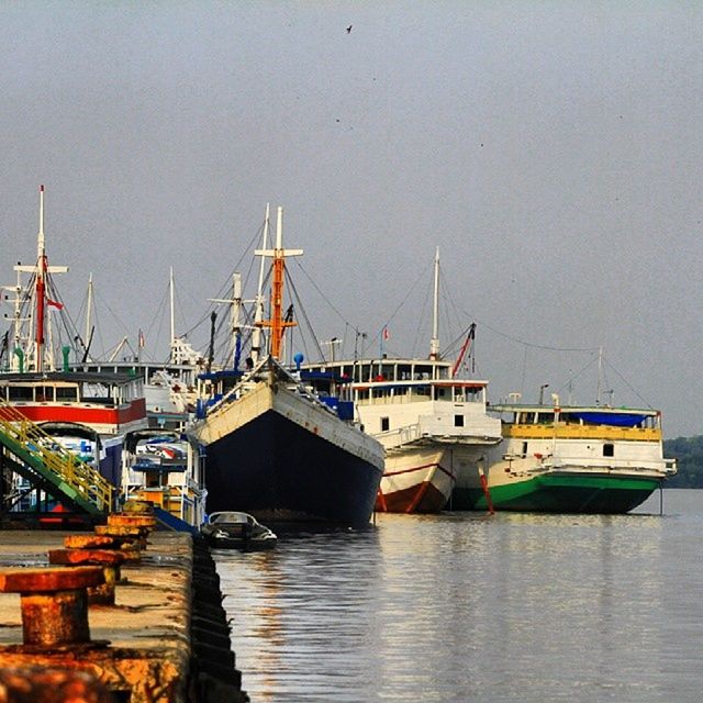 nautical vessel, water, transportation, boat, moored, mode of transport, waterfront, harbor, clear sky, sea, mast, copy space, built structure, commercial dock, reflection, architecture, building exterior, river, lake, sky