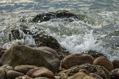 Waves splashing on rocks at beach