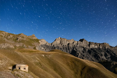 Scenic view of mountains against sky at night