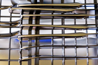 Close-up of eating utensils in dishwasher