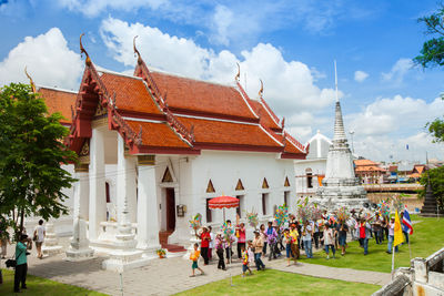 Group of people outside temple against buildings