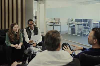 Group of business people having meeting in lobby