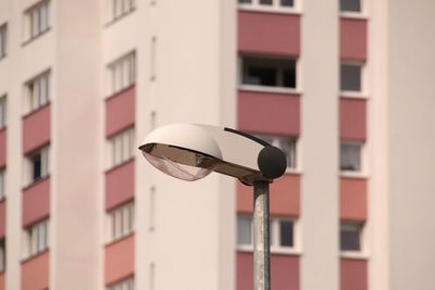 Low angle view of street light against building