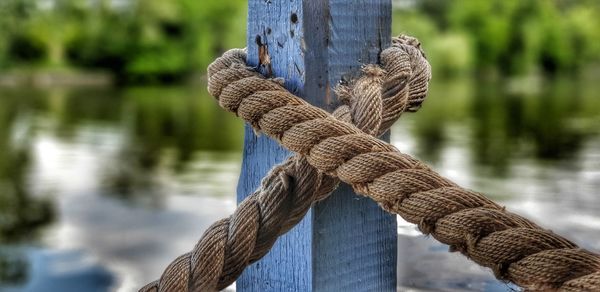 Close-up of rope tied on wooden post