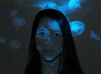 Portrait of young woman in aquarium