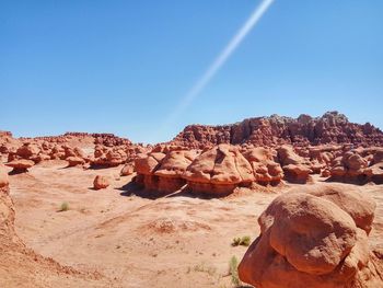 Rock formations in desert against blue sky