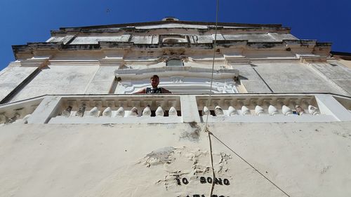 Low angle view of man standing at historical building