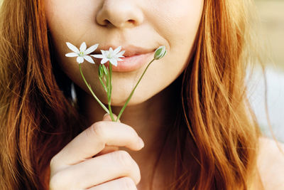 Close-up of woman holding plant