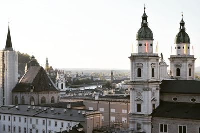 Buildings in city against clear sky