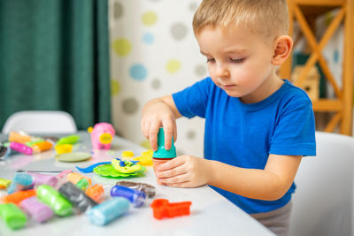 Close-up of boy playing with toys at home