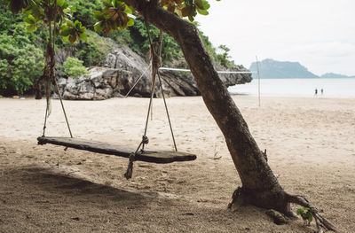 View of swing on beach against sky