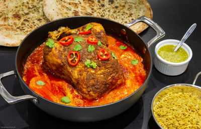 High angle view of one-pot spiced roast chicken in cooking pan