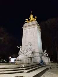 Low angle view of statue at night