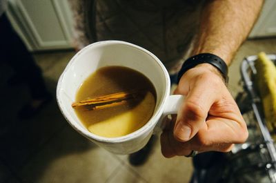 Close-up of man holding coffee cup