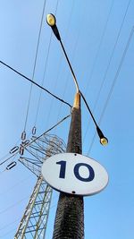 Low angle view of telephone pole against clear sky