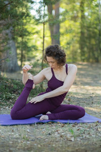Young woman exercising on field
