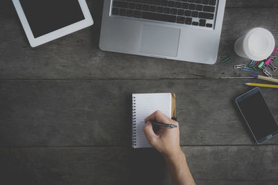 Low section of person using laptop on table