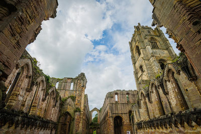 Low angle view of old ruins against sky