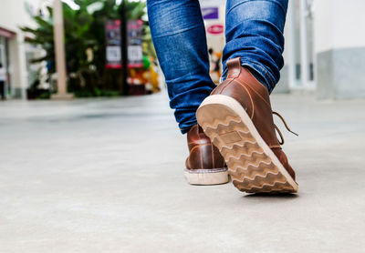 Low section of man walking on footpath