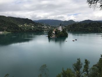 Scenic view of lake by buildings against sky