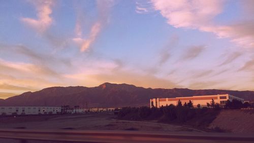 Scenic view of mountains against cloudy sky