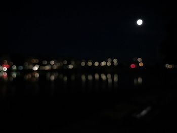 Close-up of illuminated lights against sky at night