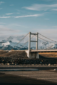 View of suspension bridge against cloudy sky