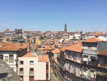 Buildings in city against blue sky